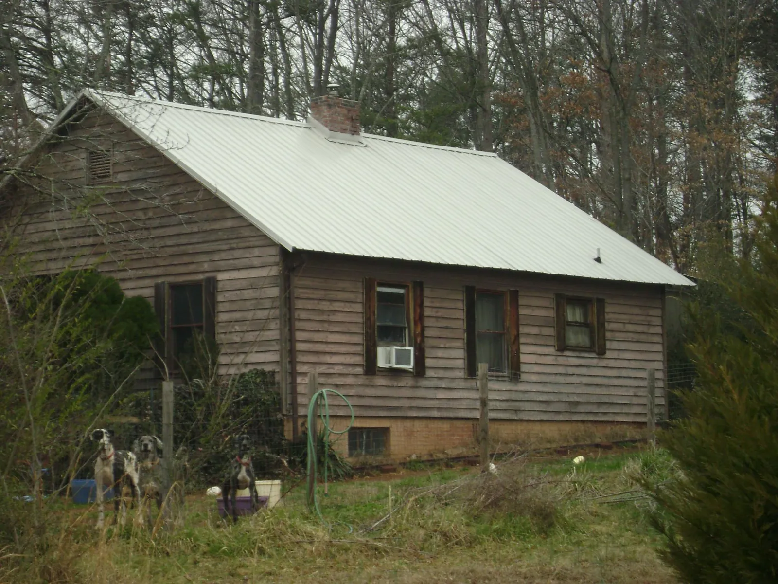 White metal roof on an old wood sided farmhouse, from a Metal Roof Installation job in Bridgeport